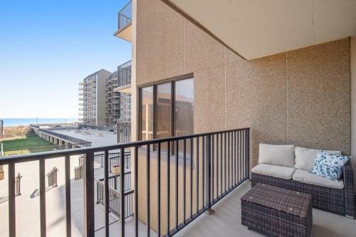 a balcony with a couch and a view of the ocean at Sea Colony --- 208 Brandywine House in Bethany Beach