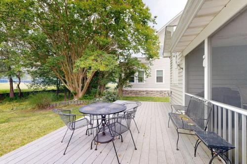 a patio with a table and chairs on a porch at Salt Pond --- 314 Walkabout Rd in Bethany Beach