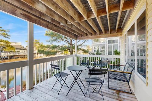 a patio with chairs and a table on a balcony at South Bethany --- 309 W 2nd St in Bethany Beach