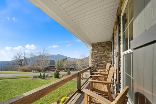 a porch with chairs and a view of the mountains at Alpine Retreat in Seven Devils