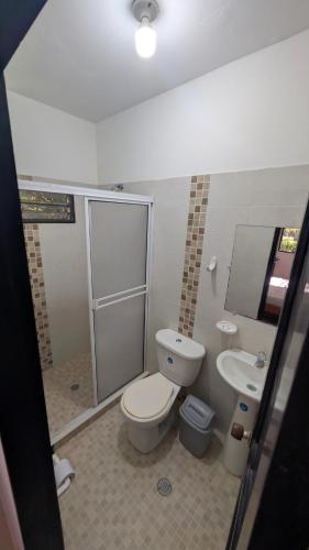 a bathroom with a toilet and a sink at Villa Jardín Con piscina y jacuzzi in Bonda