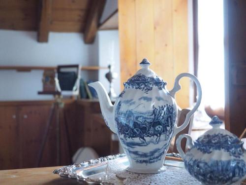 two blue and white vases sitting on a table at Saxonis Houses & Saxonis Villa in Papigko