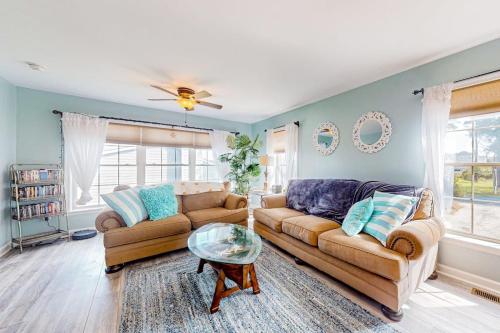 a living room with a couch and a table at The Reservation --- 38601 Indian Trail in Ocean View