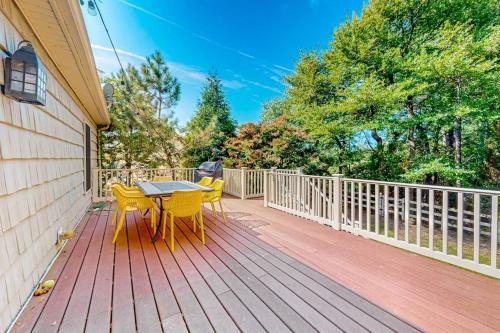 a wooden deck with a table and chairs on it at The Reservation --- 38601 Indian Trail in Ocean View
