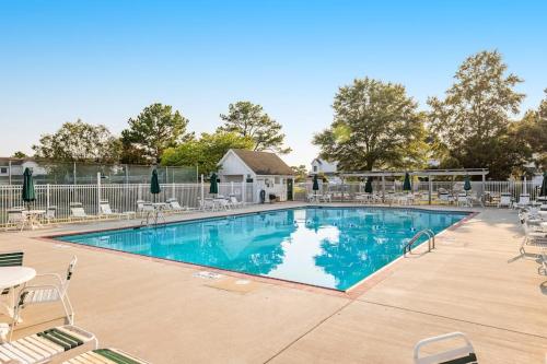 a large swimming pool with chairs and tables at Mallard Lakes --- 38082 Mockingbird Ln Unit #48 in Selbyville
