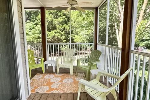 a screened porch with rocking chairs and a table at Sea Colony --- 55032 Pine Lake Dr in Bethany Beach