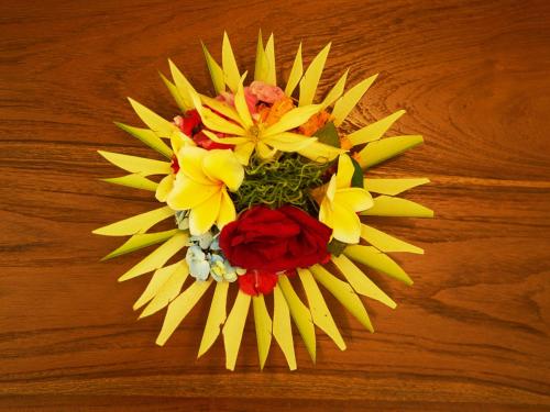a bouquet of flowers on top of a wooden table at Eden House Ubud in Ubud