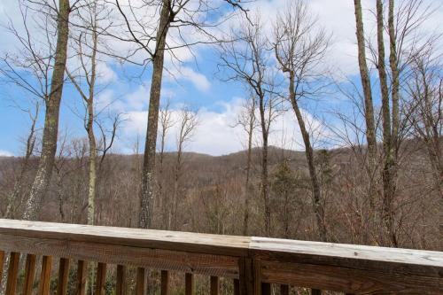 a wooden deck with a view of the woods at Little Elk Lodge in Elk Park