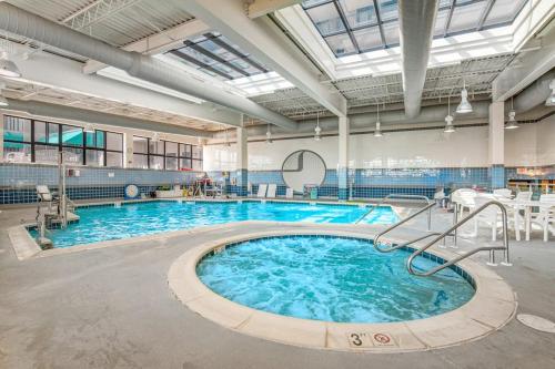 a large swimming pool with blue water in a building at Sea Colony - 55073 Pine Shore in Bethany Beach