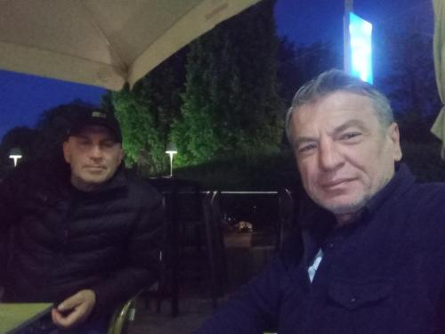 two men sitting next to each other in a room at Tepelen Albania in Tepelenë