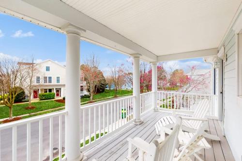 a white porch with two white chairs on it at Bear Trap Dunes - 53 October Glory Ave in Ocean View