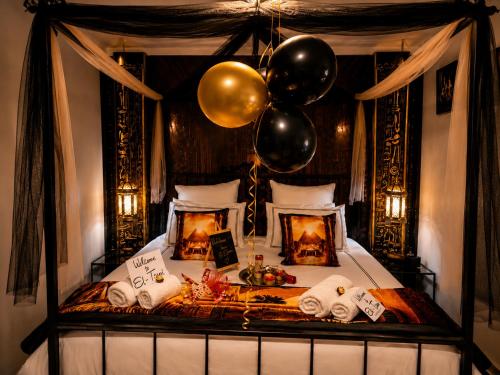 a bedroom with a bed with balloons on it at Hartbeespoort - El-Tsuri Guest Resort in Hartbeespoort
