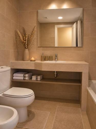a bathroom with a toilet and a sink and a mirror at Duquesa Coto Real in Manilva