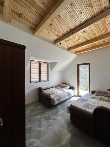 a room with two beds and a couch in it at Etno village Bare in Bare
