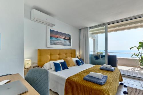 a bedroom with a bed with a view of the ocean at Calatabarca B&B in Tabarca