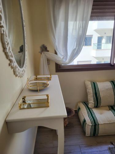 a bathroom with a sink and a mirror and a window at sunny amazigh apt avev piscine pool steps from beach 2balcony 2smartTV pool in Essaouira