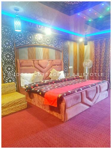 a bedroom with a large bed in a room at Budget Cottage By Aristotle in Srinagar