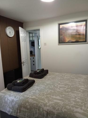 a bedroom with two ottomans on a bed at Swannery Vista 1 Bedroom Apartment in Weymouth