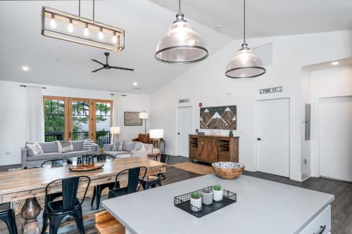 a kitchen and living room with a table and chairs at Cardinal On Main in Blowing Rock