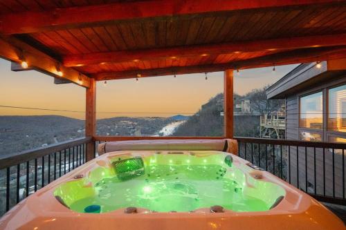 a hot tub on the balcony of a house at Soaring Eagles View in Beech Mountain