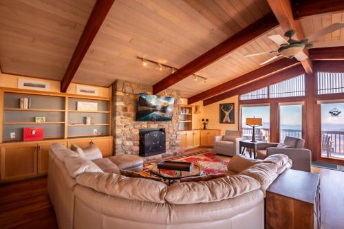 a living room with a large couch and a fireplace at Pinnacle Ridge Sunrise Sunsets in Beech Mountain