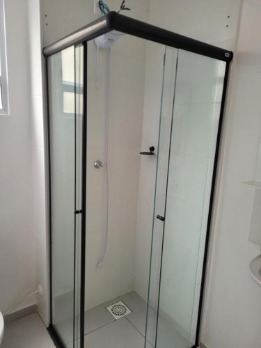 a shower with a glass door in a bathroom at Lugar tranquilo in Biguaçu