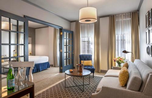 a living room with a couch and a bed at Warwick San Francisco in San Francisco