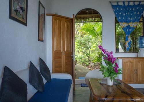a living room with a blue couch and a table at Kim's Garden in Anda