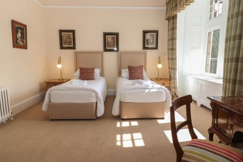 a hotel room with two beds and a window at Bynack - Mar Lodge Estate in Ballater