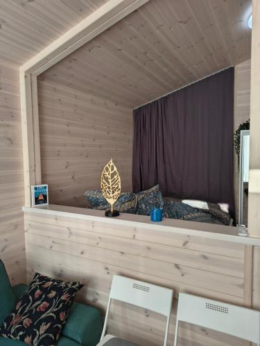 a bedroom with a bed and two white chairs at Tiny House Am Guckenberg in Diez in Diez