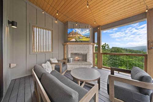 a living room with a table and a fireplace at Luxury Trails Escape in Boone