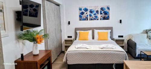 a small bedroom with a bed and a couch at Parga kamara studio in Parga