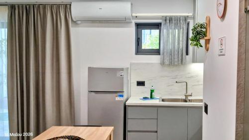 a small kitchen with a sink and a refrigerator at Parga kamara studio in Parga