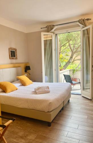a bedroom with a large bed and a sliding glass door at Hotel Il colle di Monterosso in Monterosso al Mare
