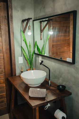 a bathroom with a sink and a mirror at The Guest House pousada in Balneário Gaivotas