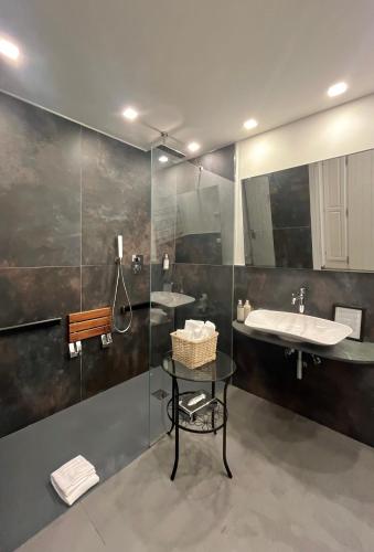 a bathroom with two sinks and a glass shower at Hotel Il colle di Monterosso in Monterosso al Mare