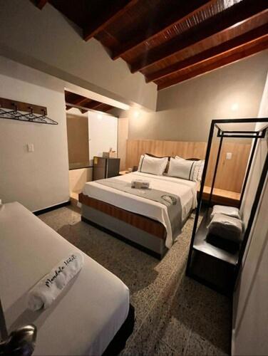 a hotel room with two beds in a room at Mandala Medellin Botero By GyC Hotels in Medellín
