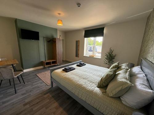 a bedroom with a bed and a table and a window at Bar 21 in Hunstanton