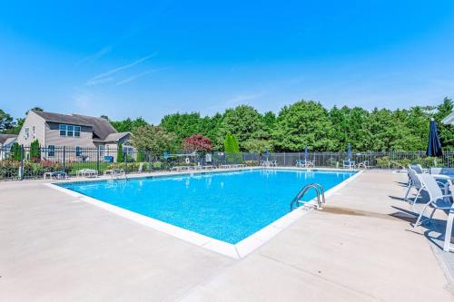a large swimming pool with chairs and a house at Bayview Landing - 38013 Bayview Circle in Selbyville