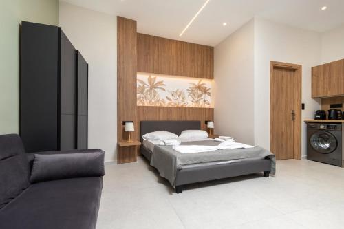 a bedroom with a bed and a couch at United Cretan Villas Boutique Studio in Agia Marina Nea Kydonias