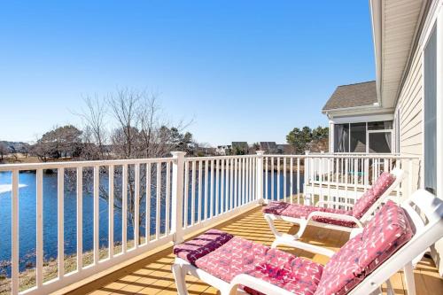 two chairs sitting on a deck overlooking the water at Bear Trap Dunes - 60F October Glory in Ocean View