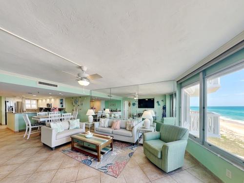 a living room with a view of the ocean at Oceanside Retreat 804 in Ormond Beach