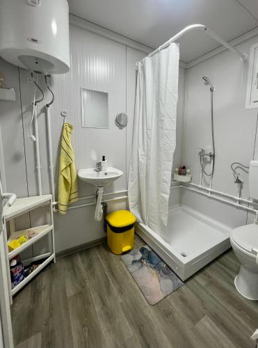 a bathroom with a shower and a tub and a sink at OffGrid Retreat Rtanj in Boljevac