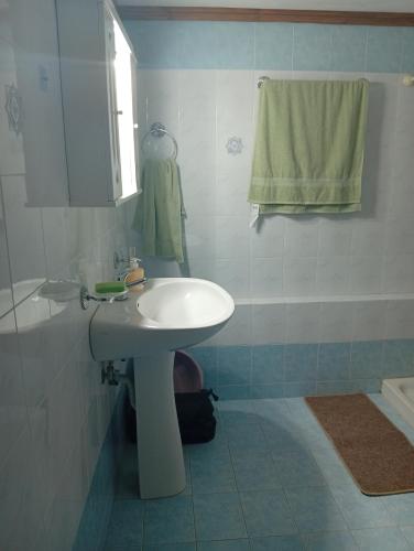 a bathroom with a white sink and a towel at Summer House 96 in Salamina