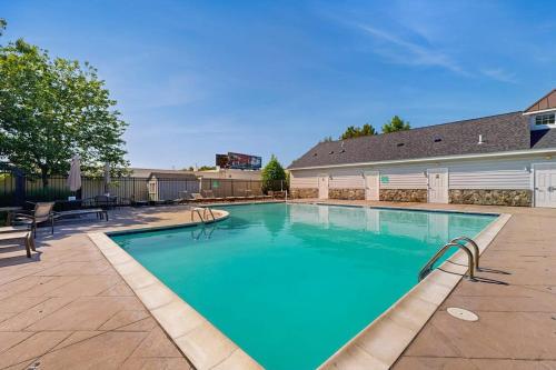 a swimming pool with blue water in a yard at Rehoboth Crossing --- 36985 Grindstone Ln in Rehoboth Beach