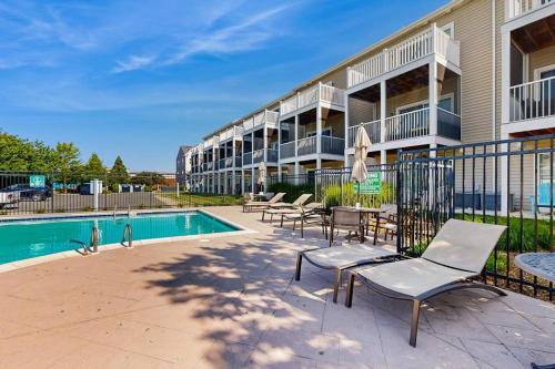 a resort with a pool and chairs and a building at Rehoboth Crossing --- 36985 Grindstone Ln in Rehoboth Beach