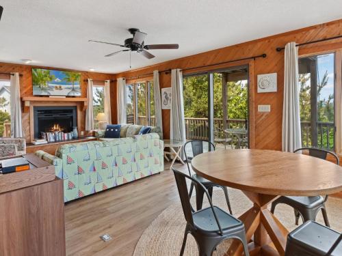 a living room with a table and chairs at 2030 - Horizon`s Summit in Duck