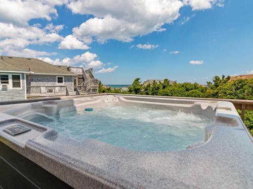 a large plunge pool on the back of a house at 2030 - Horizon`s Summit in Duck