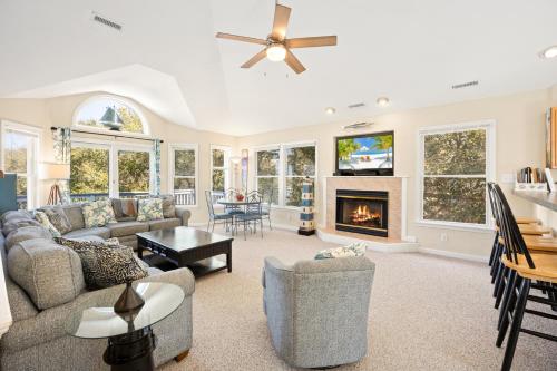 a living room with a couch and a fireplace at 2020 - Merryweather in Sanderling