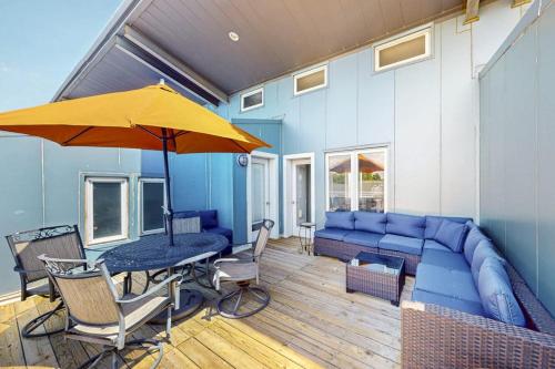 a living room with a blue couch and an umbrella at Rehoboth Beach --- Forj Lofts, Unit #2 in Rehoboth Beach